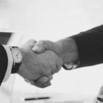 Partners shaking hands black & white image