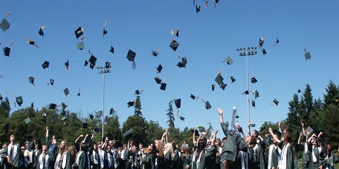 Graduates throwing their cap